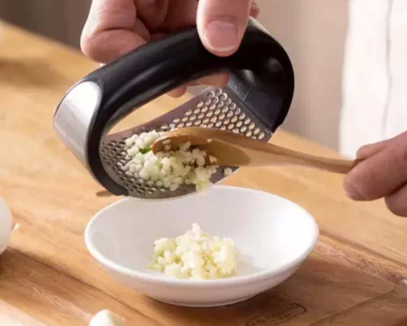 High-quality stainless steel garlic presser for kitchen use.