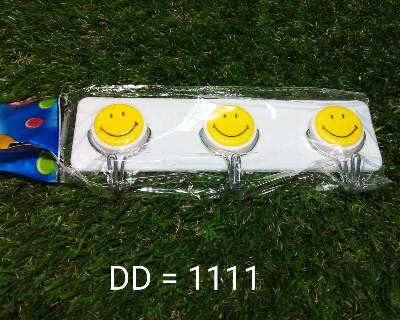 Bright and fun smiley face wall hooks for kids’ rooms.