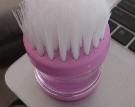 Multicolour plastic wash basin brush cleaner with soap dispenser.