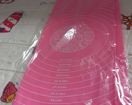 Detailed view of silicone baking mat in use for rolling dough