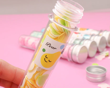 Test tube containing flower-shaped paper soap strips for travel.