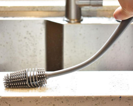 Brush with a long handle for bottle cleaning.