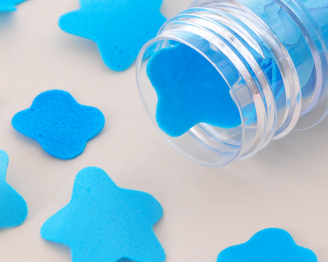 Flower-shaped paper soap strips in a compact test tube bottle.
