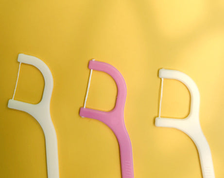 Handy floss sticks for easy tooth cleaning.