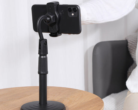 Desktop mobile stand, height adjustable, ideal for hands-free phone usage on tables.