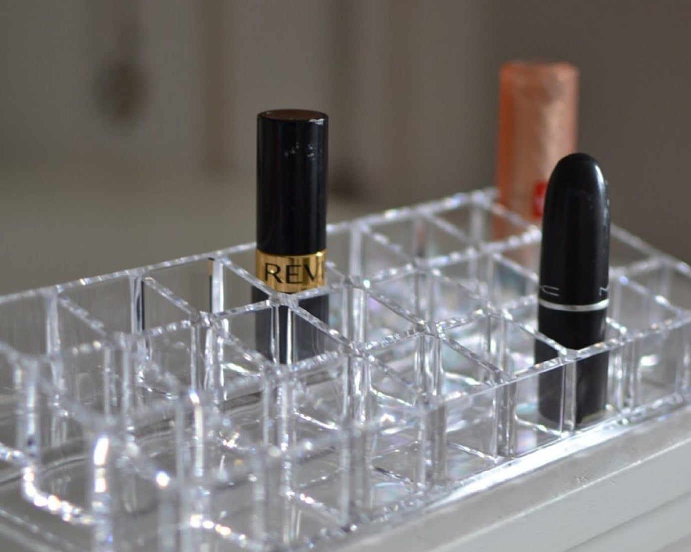 Close-up view of the acrylic lipstick holder, highlighting the clarity and design of the 24 sections