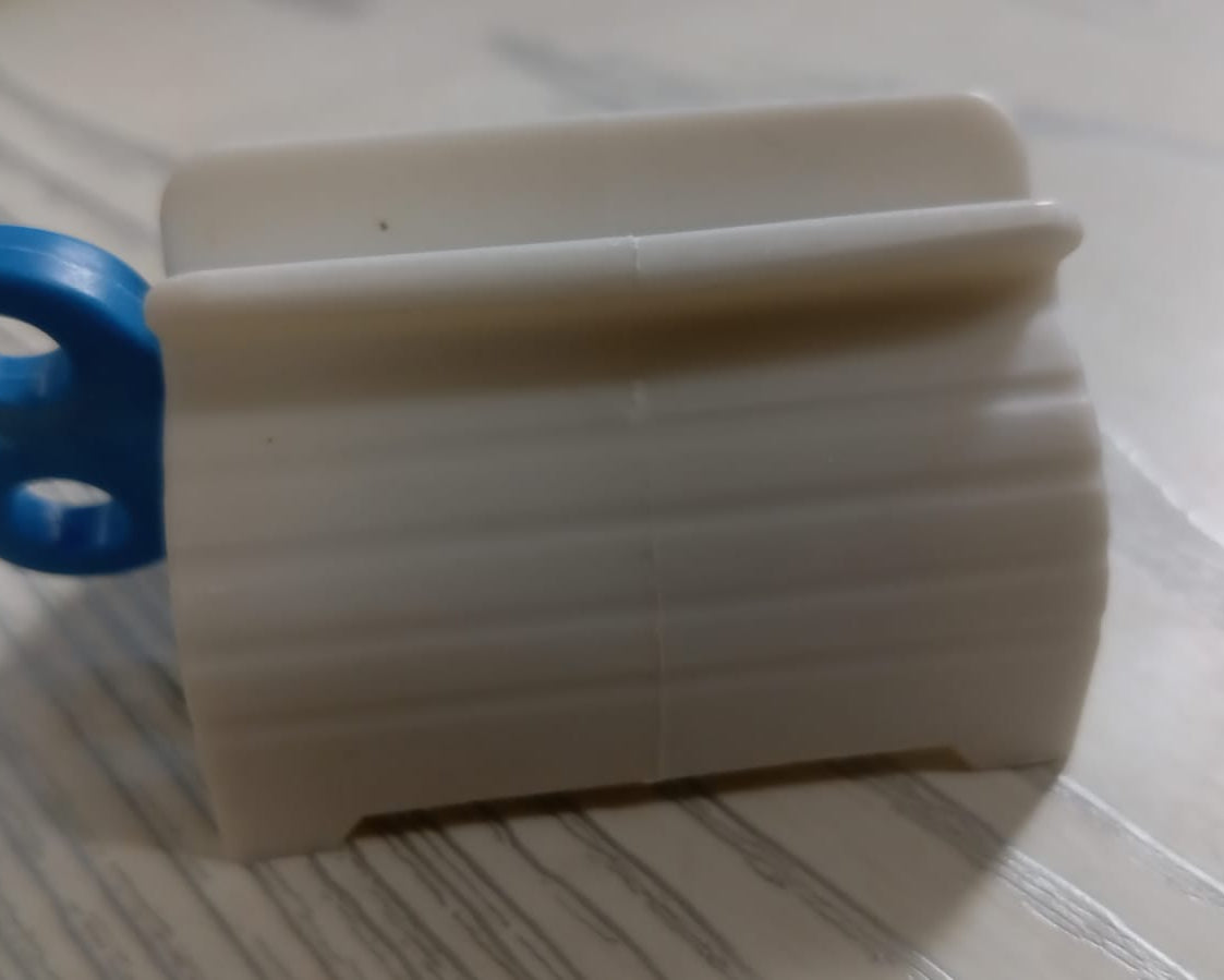 Tube toothpaste squeezer with seat holder for convenience